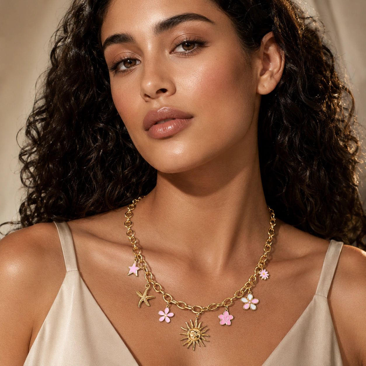 Gold celestial floral necklace styled in an elegant jewellery flat lay
