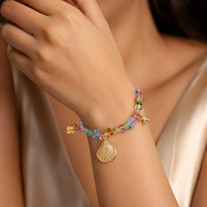 Side view of the gold coastal shell starfish bracelet