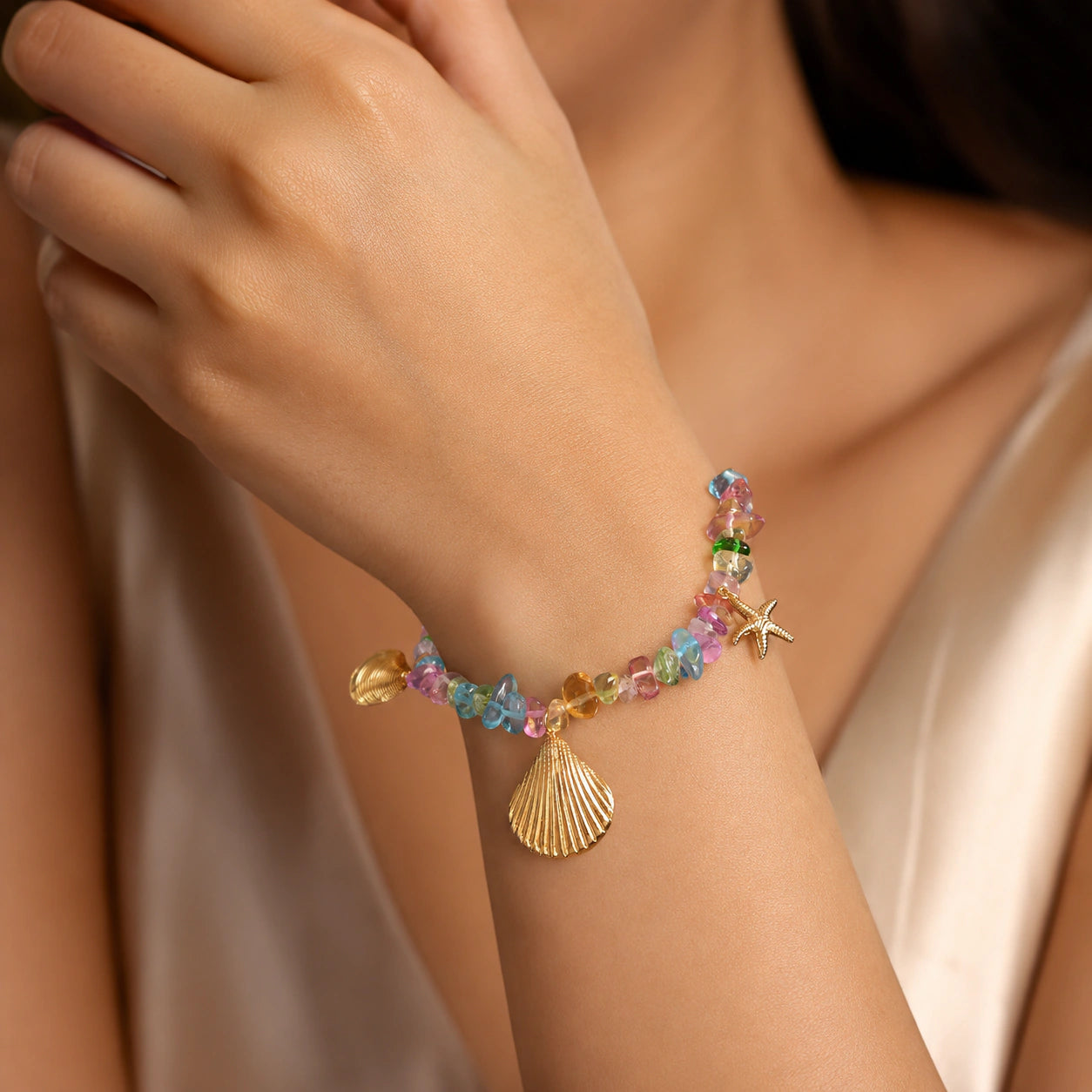 Side view of the gold coastal shell starfish bracelet