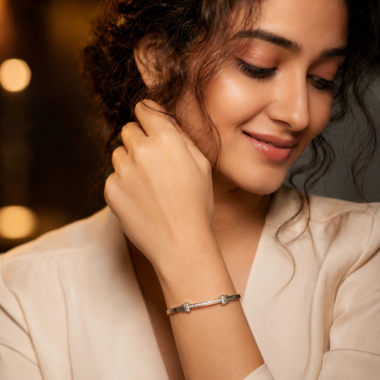 Angled view of the gold crystal-bar rigid bangle
