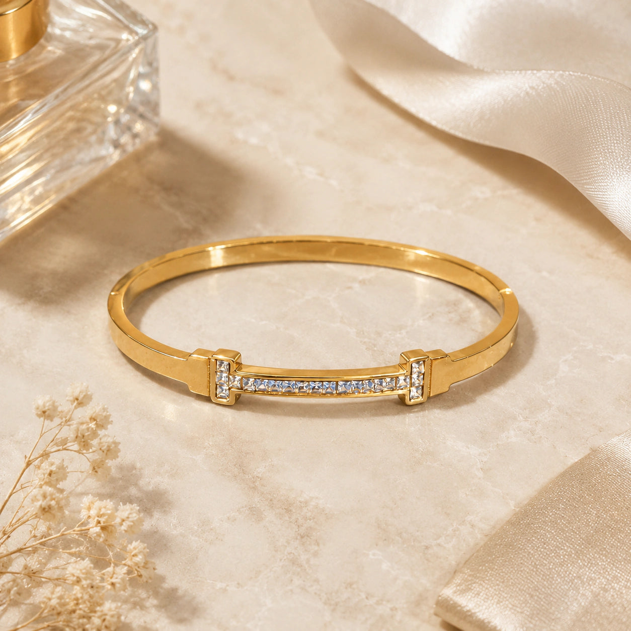 Close-up of crystal bars and gold bangle detailing