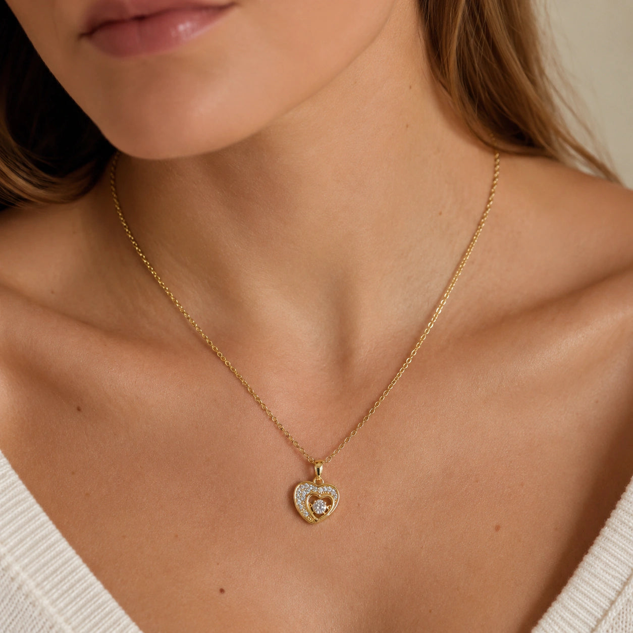 Alternate detail view of the gold double-heart crystal pendant