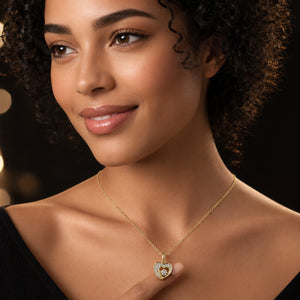 Angled view of the gold crystal double-heart pendant necklace
