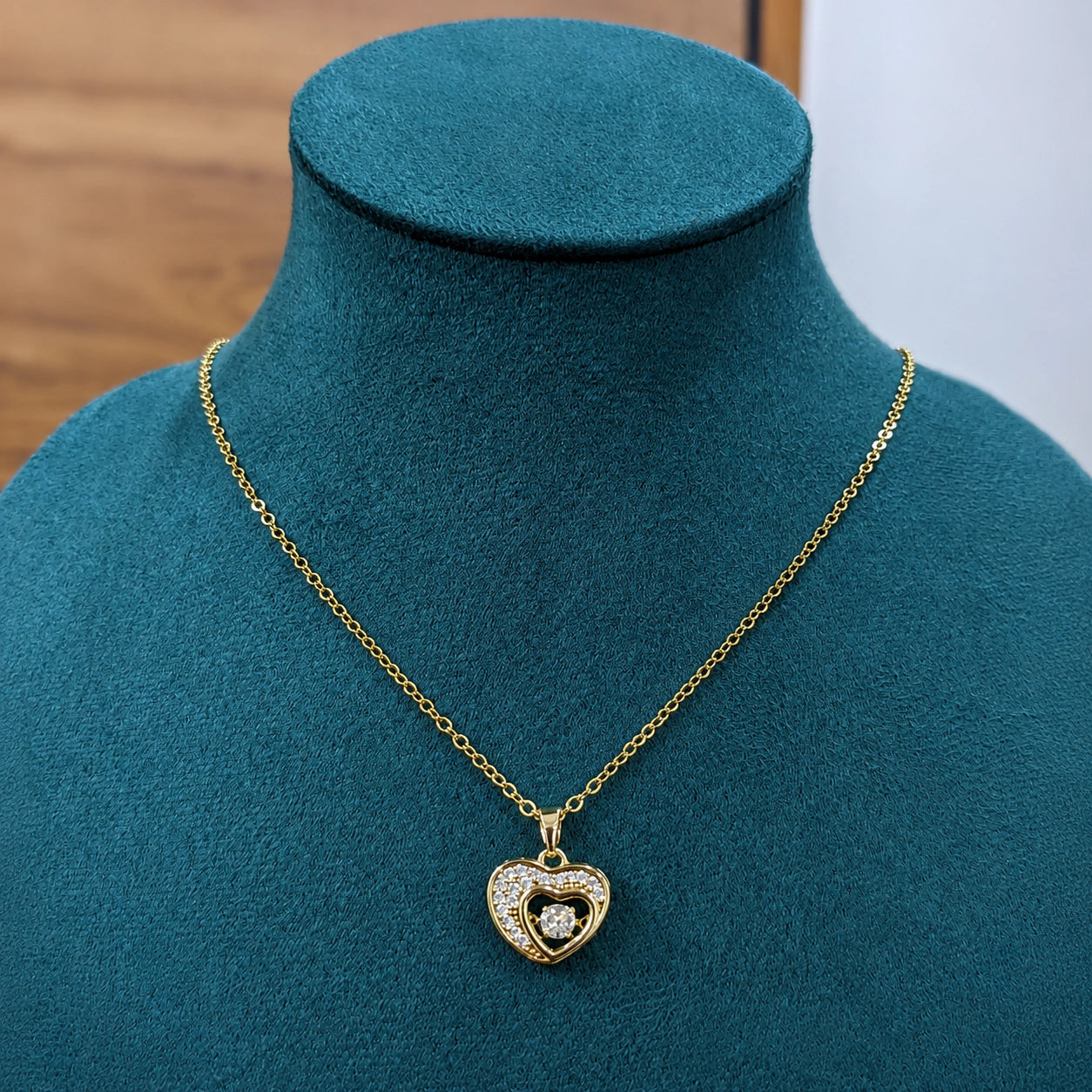 Gold double-heart necklace styled in an elegant jewellery flat lay
