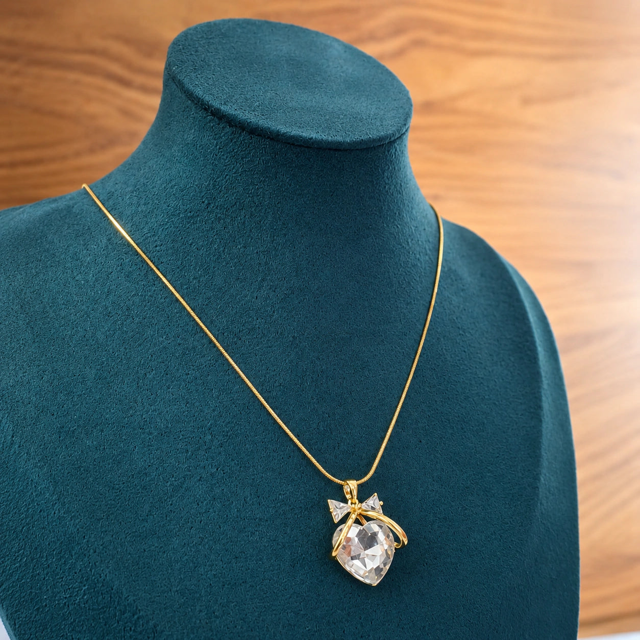 Alternate detail view of the gold heart bow pendant