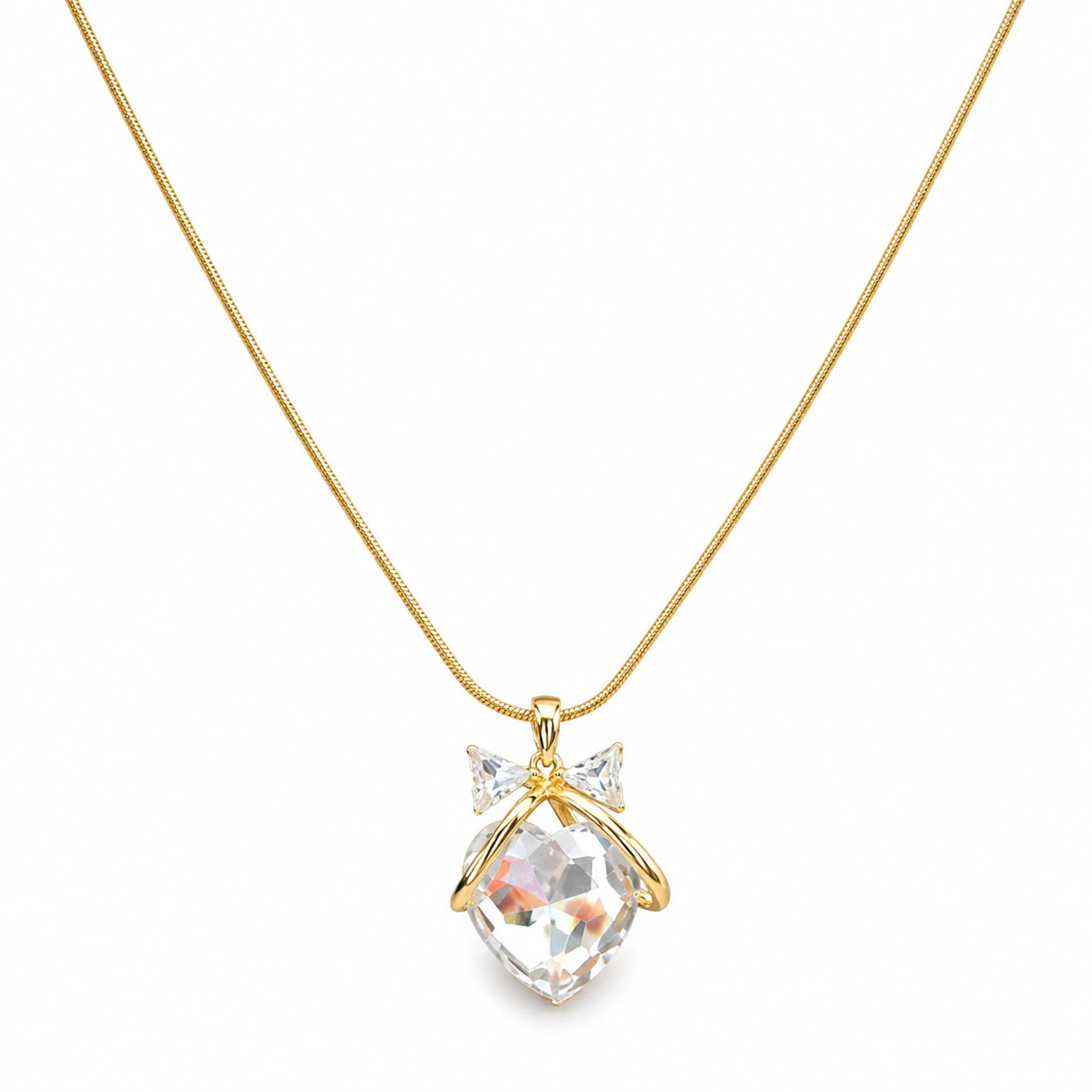 Close-up of the crystal heart and sculpted bow pendant detailing