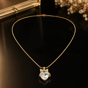 Side view of the gold crystal heart bow pendant necklace