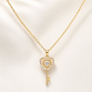 Angled view of the gold crystal heart key pendant necklace