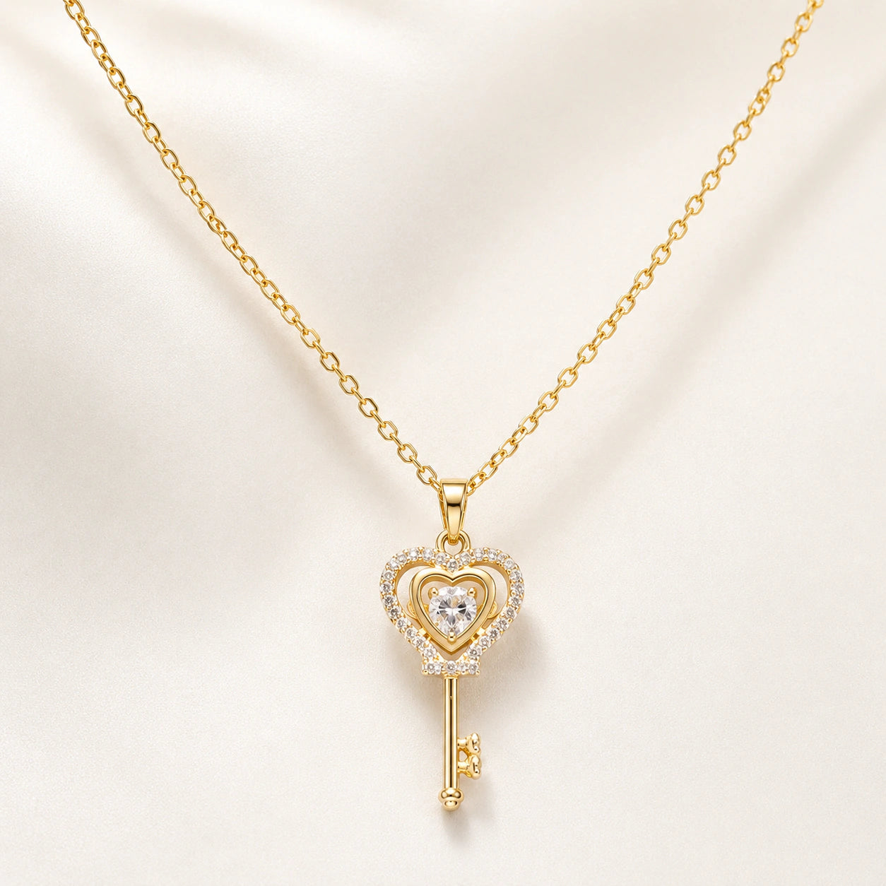 Angled view of the gold crystal heart key pendant necklace