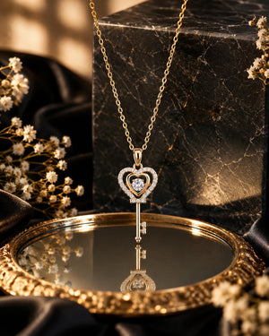 Gold crystal heart key pendant necklace worn by a model