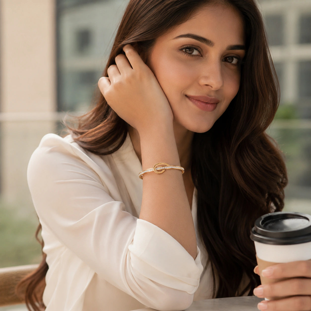 Gold crystal leaf knot kada on a dark jewellery studio display