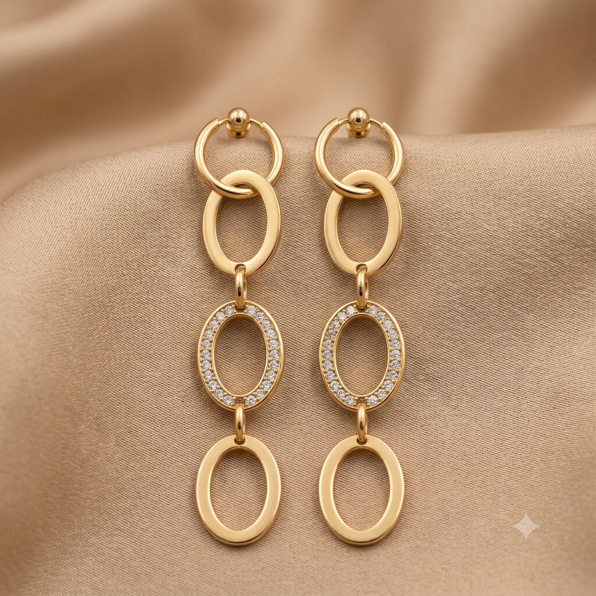 Gold oval-link statement earrings styled in an elegant jewellery flat lay