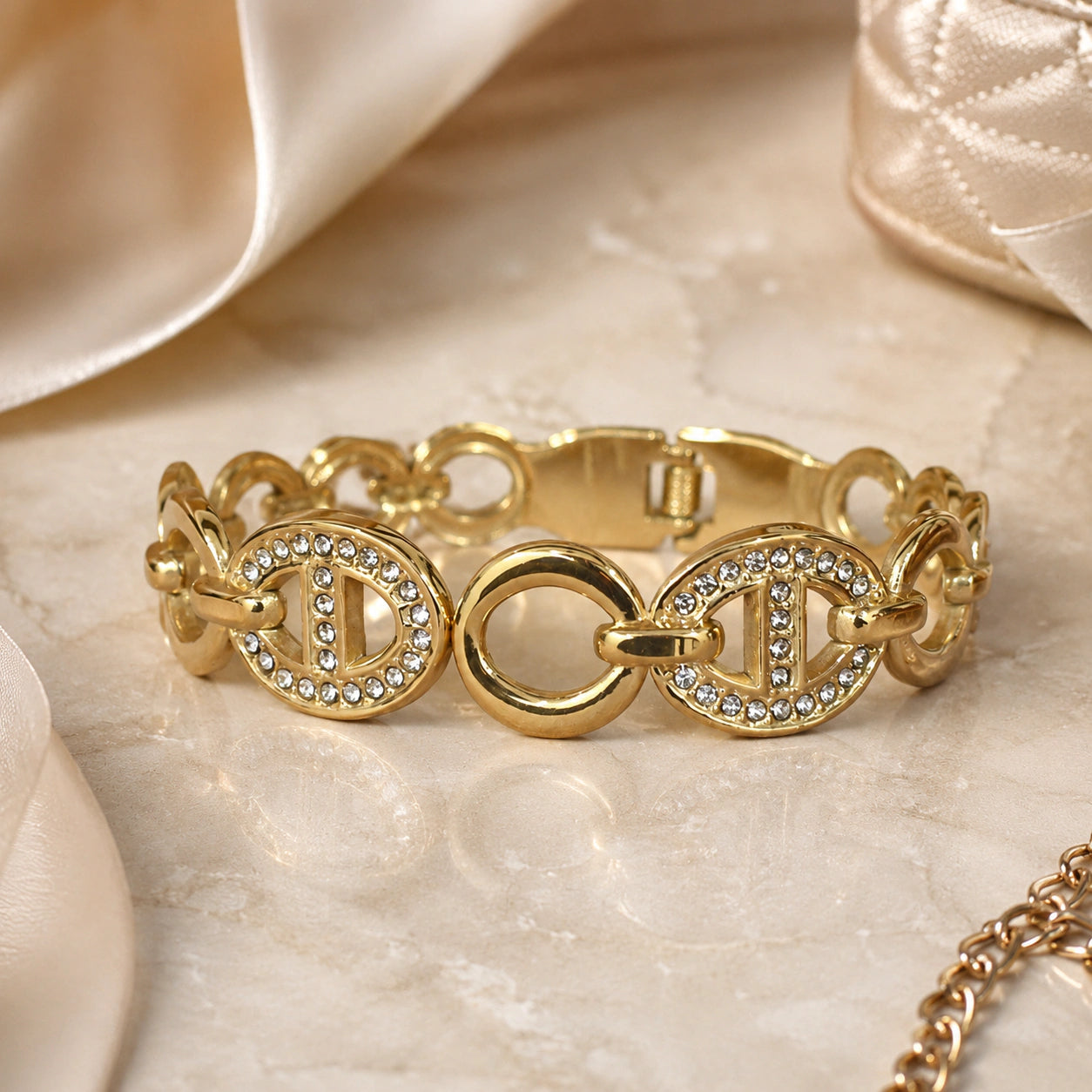 Angled view of the gold crystal oval-medallion bracelet