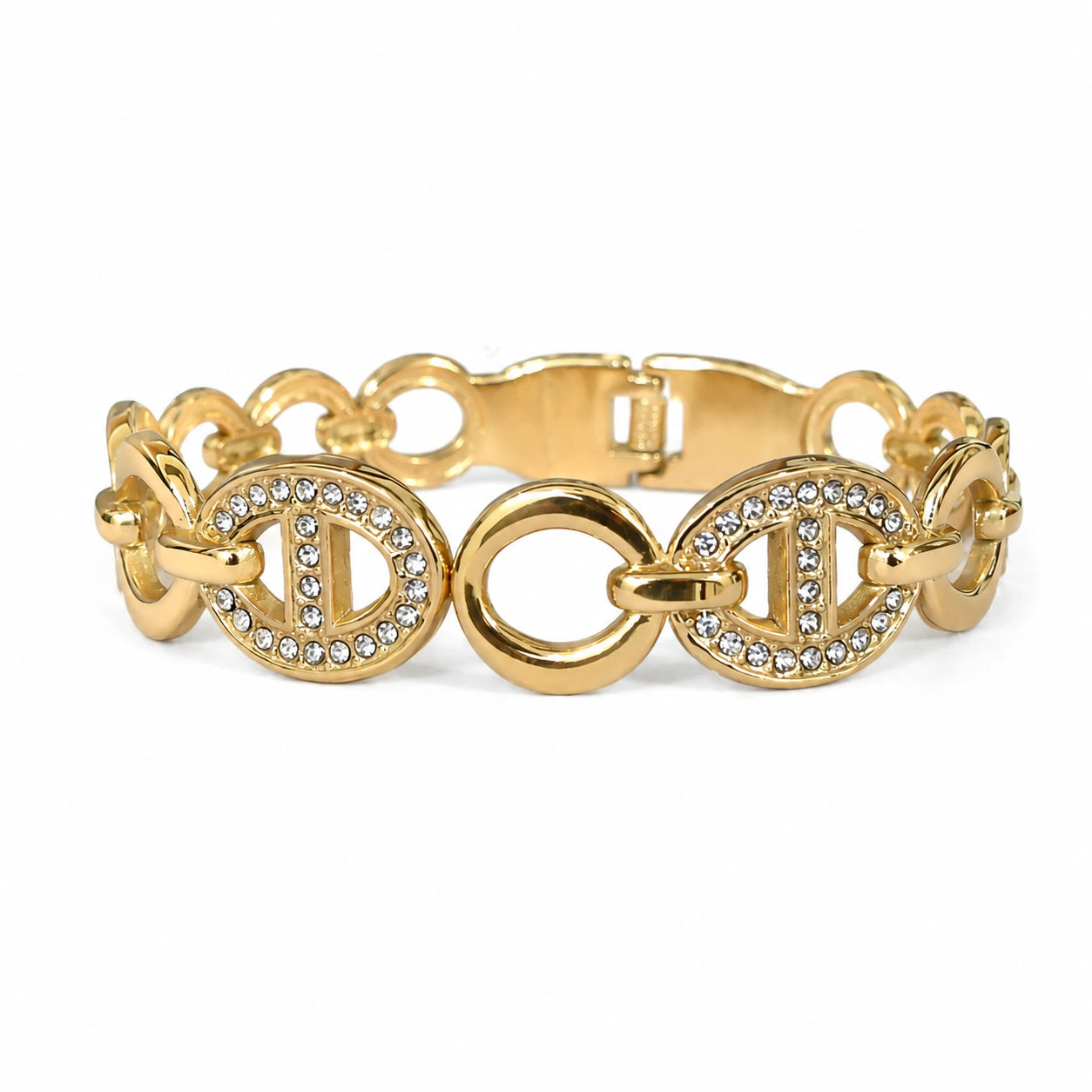 Gold crystal oval-medallion bracelet on a dark jewellery studio display