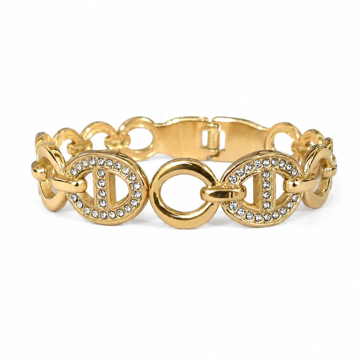 Gold crystal oval-medallion bracelet on a dark jewellery studio display