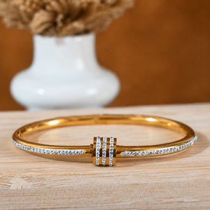 Close-up of crystal teardrops and layered kada detailing