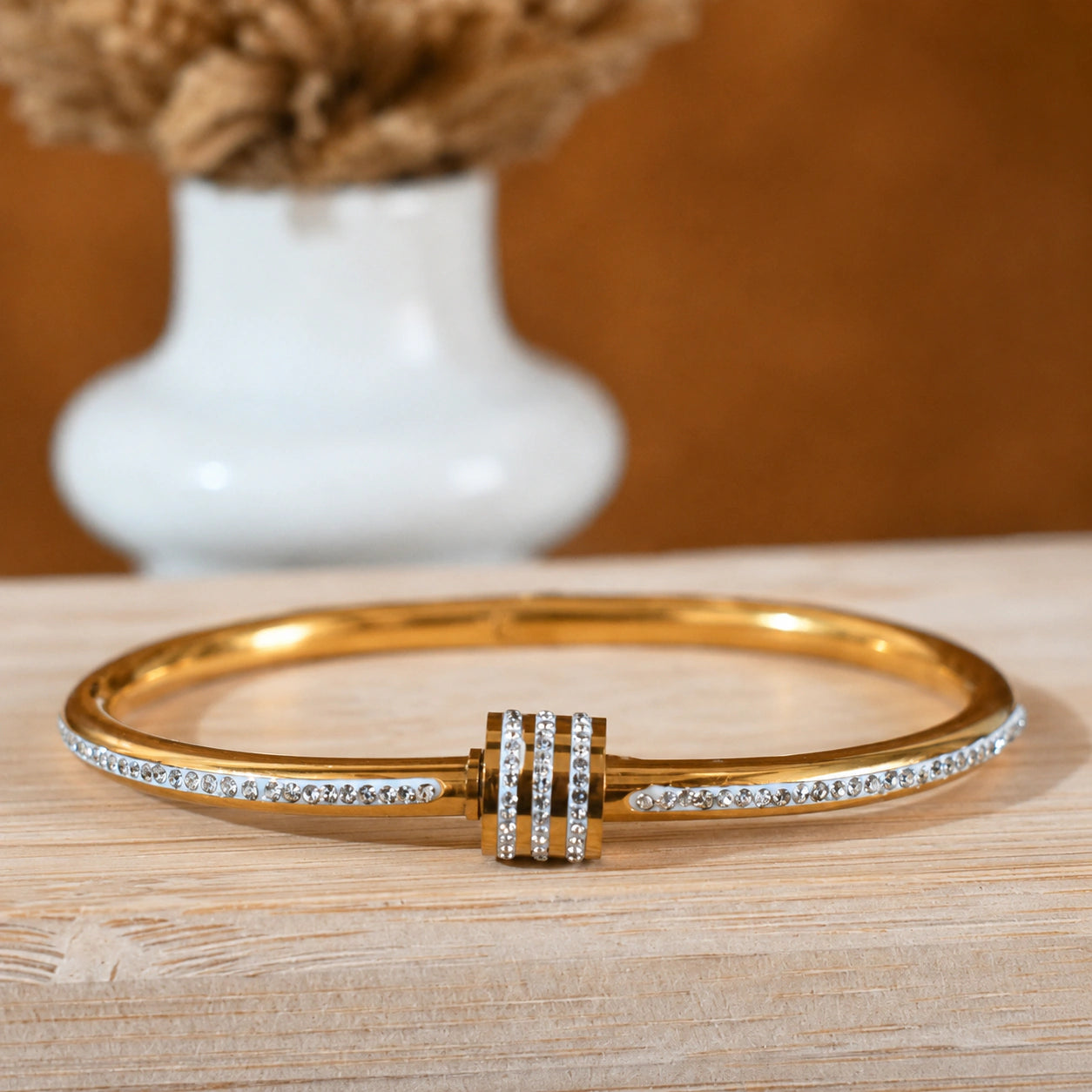 Close-up of crystal teardrops and layered kada detailing