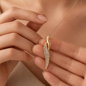 Angled view of the gold curved crystal twist necklace