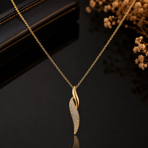 Gold curved twist necklace styled in an elegant jewellery flat lay