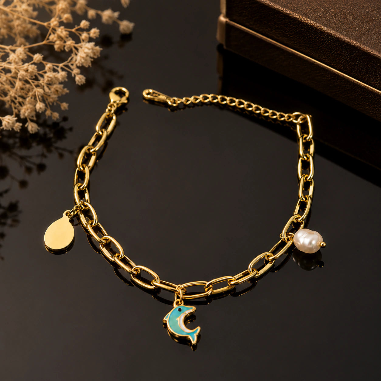 Close-up of dolphin motifs and pearl-style charm detailing