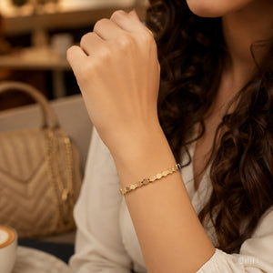 Angled view of the gold faceted geometric bracelet