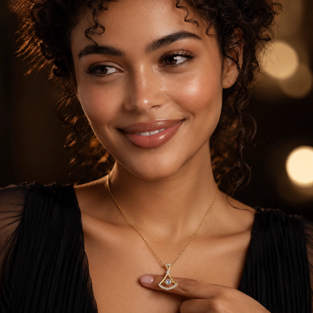 Angled view of the gold fan-frame crystal pendant necklace