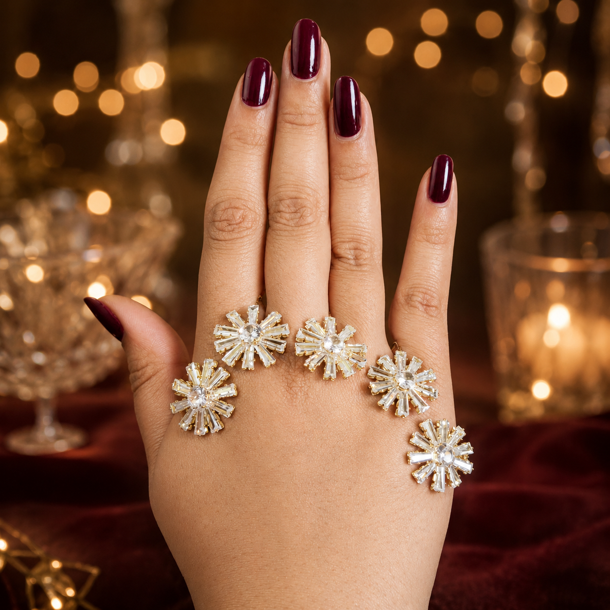 Close-up of five crystal starbursts and gold-tone detailing