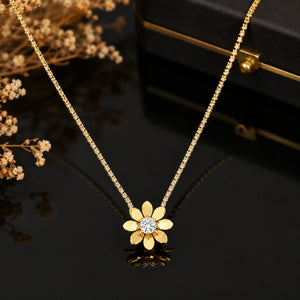 Gold floral stone-chain necklace styled in an elegant jewellery flat lay