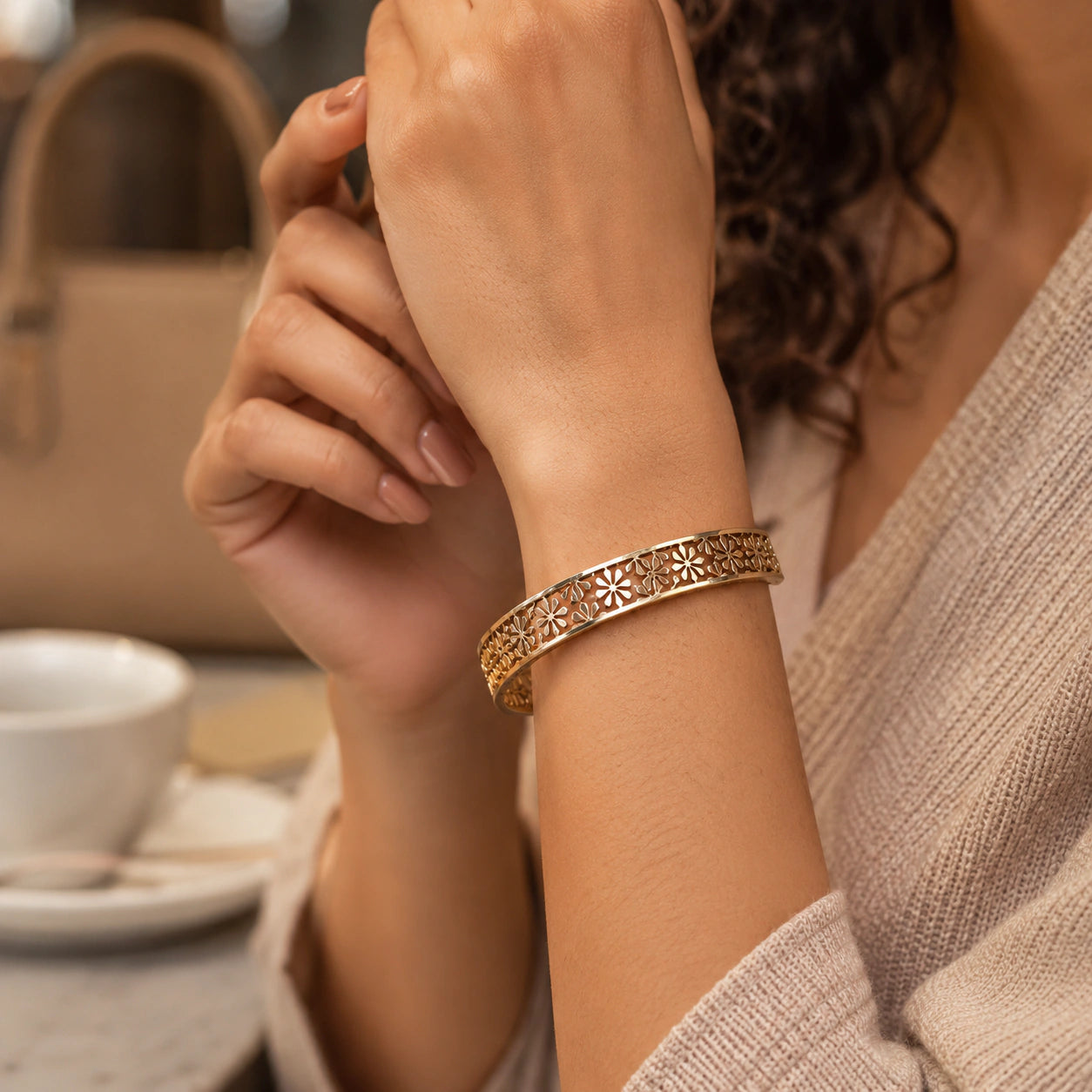 Angled view of the gold floral openwork hinged kada