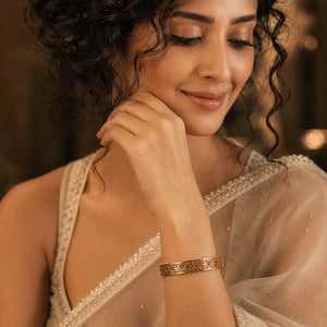 Side view of the gold floral openwork hinged kada