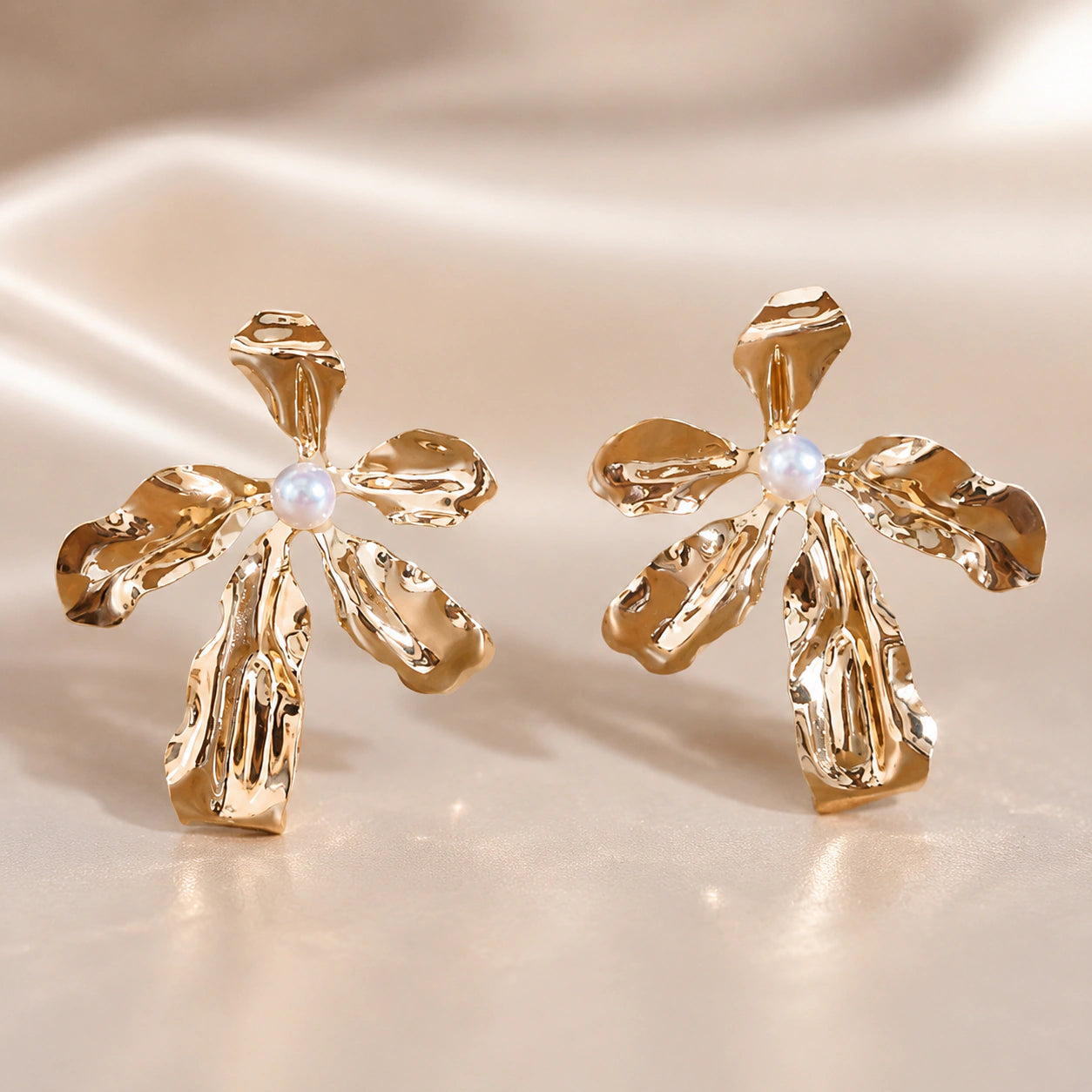 Close-up of sculpted gold flowers and pearl-style drops