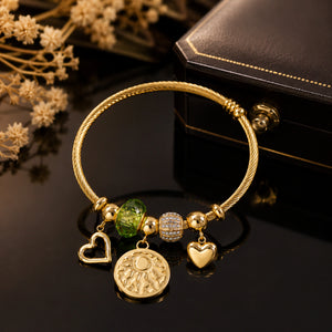 Close-up of green beads, heart medallion and twisted cable detailing