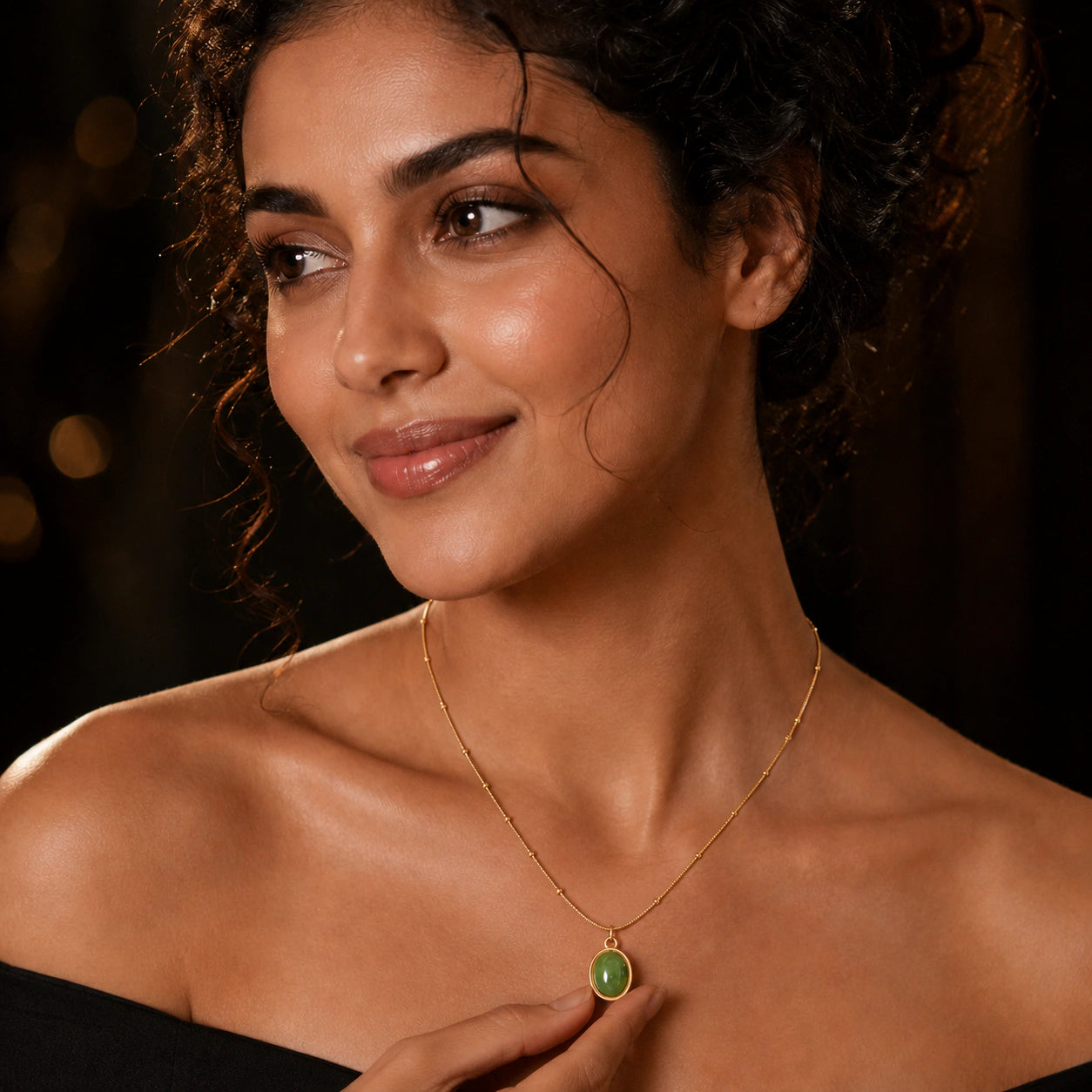 Gold green cabochon necklace styled in an elegant jewellery flat lay