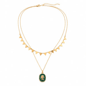 Angled view of the gold green cameo triangle layered necklace