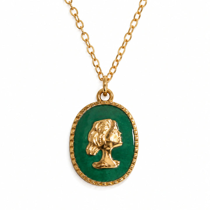 Gold green cameo layered necklace on a dark jewellery studio display