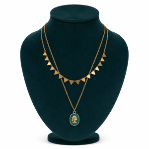 Gold green cameo necklace styled in an elegant jewellery flat lay