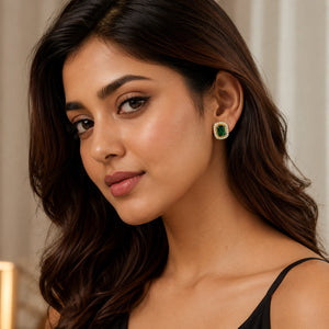 Angled view of the gold green halo stud and hoop earring set