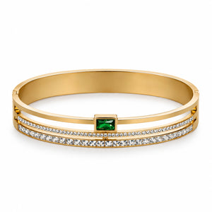 Close-up of green rectangular crystals and gold bangle detailing