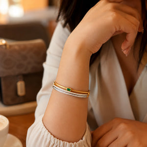 Side view of the gold green rectangular crystal bangle