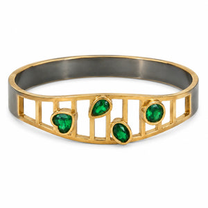 Gold green stone openwork kada on a dark jewellery studio display