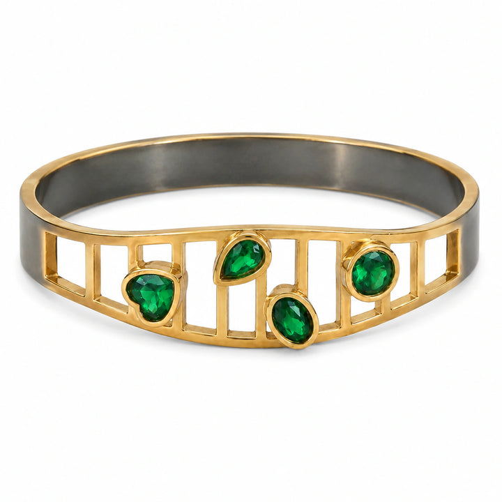 Gold green stone openwork kada on a dark jewellery studio display
