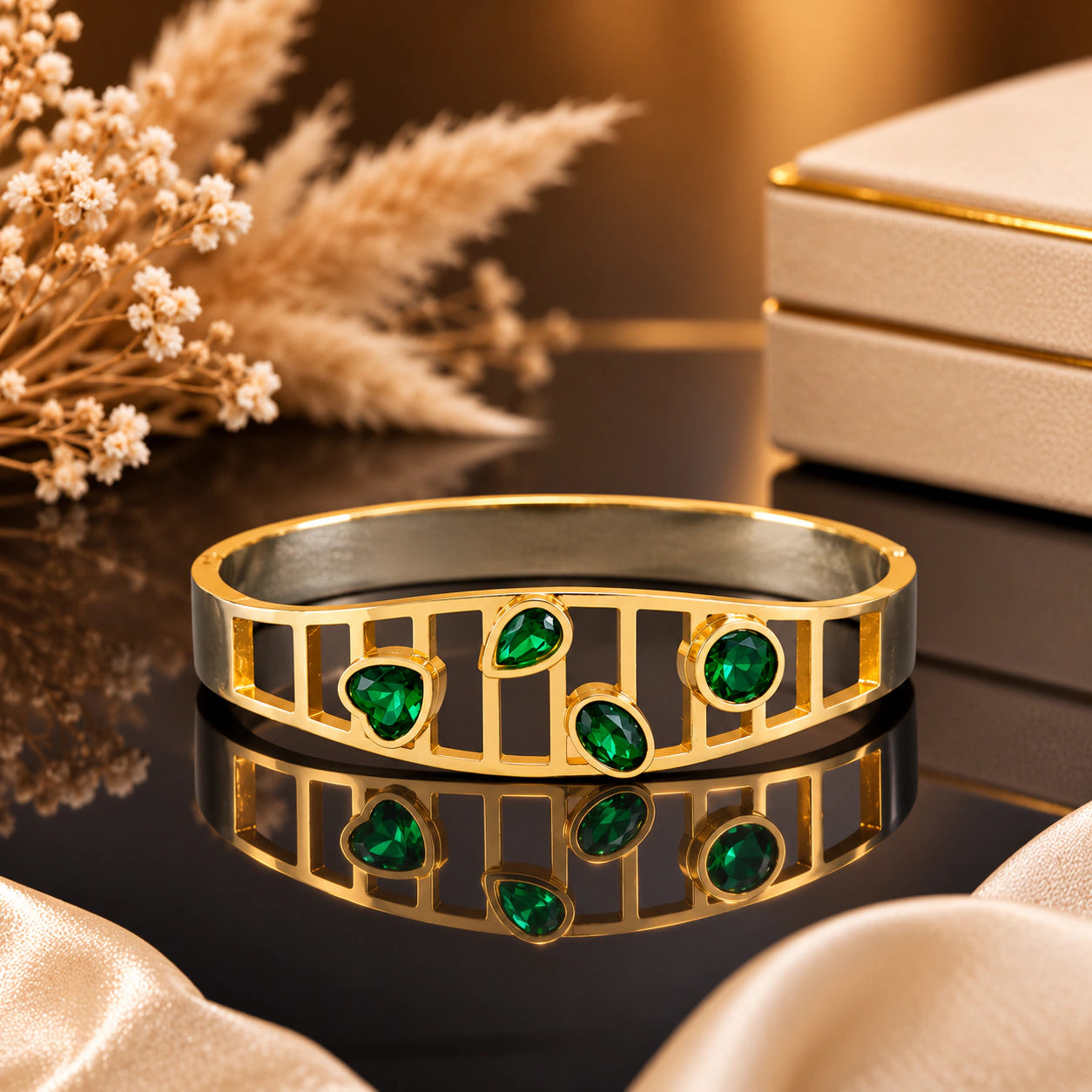 Close-up of green stones and gold openwork detailing