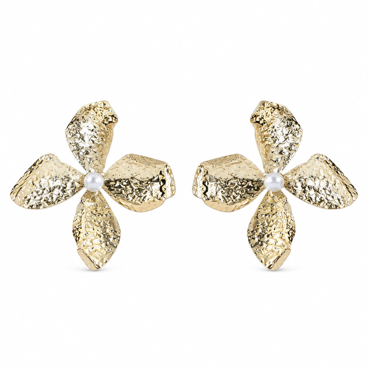 Gold hammered floral pearl earrings on a dark jewellery studio display