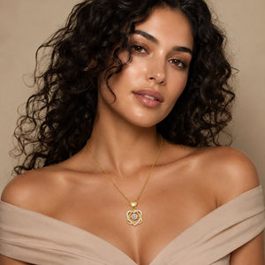 Gold crystal knot necklace styled in an elegant jewellery flat lay