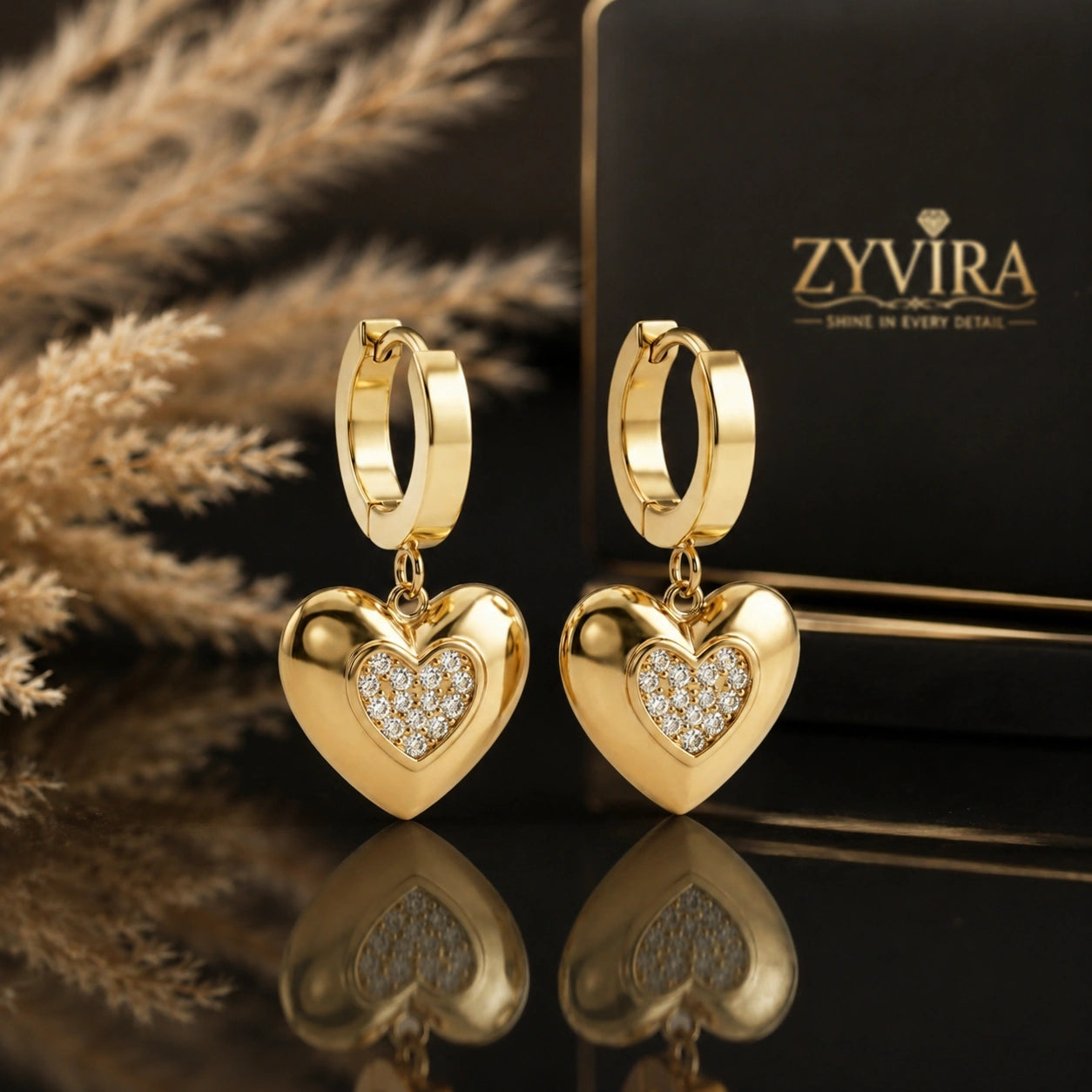 Gold heart charm huggie hoops styled in an elegant jewellery flat lay