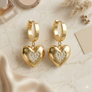 Close-up of pavé-style heart charms and huggie hoop detailing