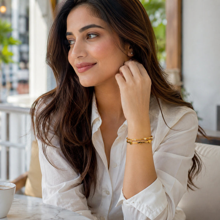 Gold heart crystal scallop kada on a dark jewellery studio display