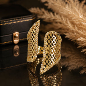 Angled view of the gold lattice wing open ring