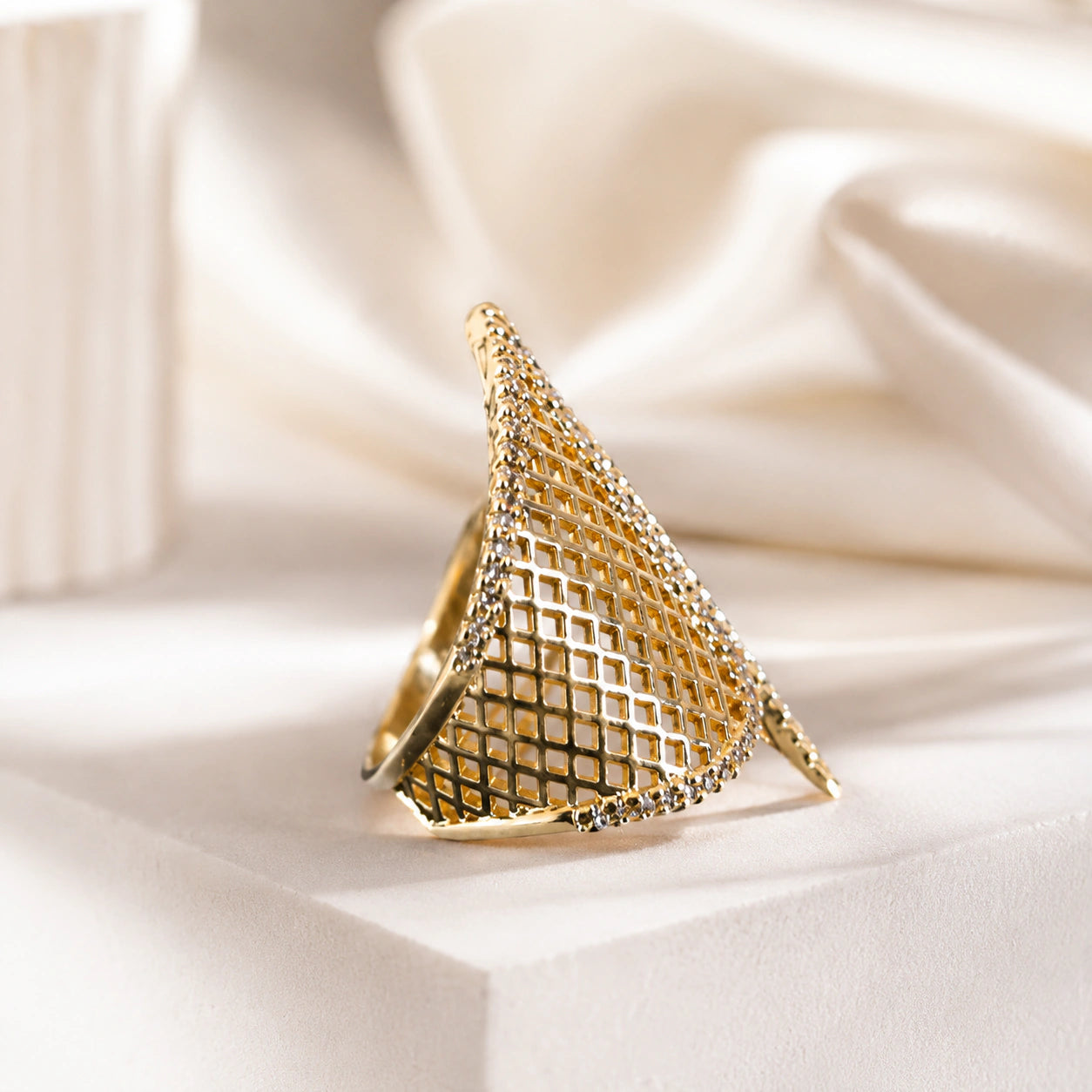 Side view of the gold lattice wing open ring