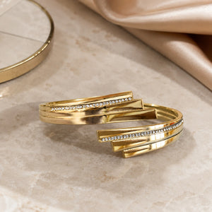 Gold layered crystal cuff styled in an elegant jewellery flat lay